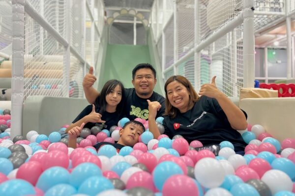 Louie and Josie, a couple in their early 40s, smiling with their two kids Isa and Luis at home — the family behind LifeSharesTogether blog